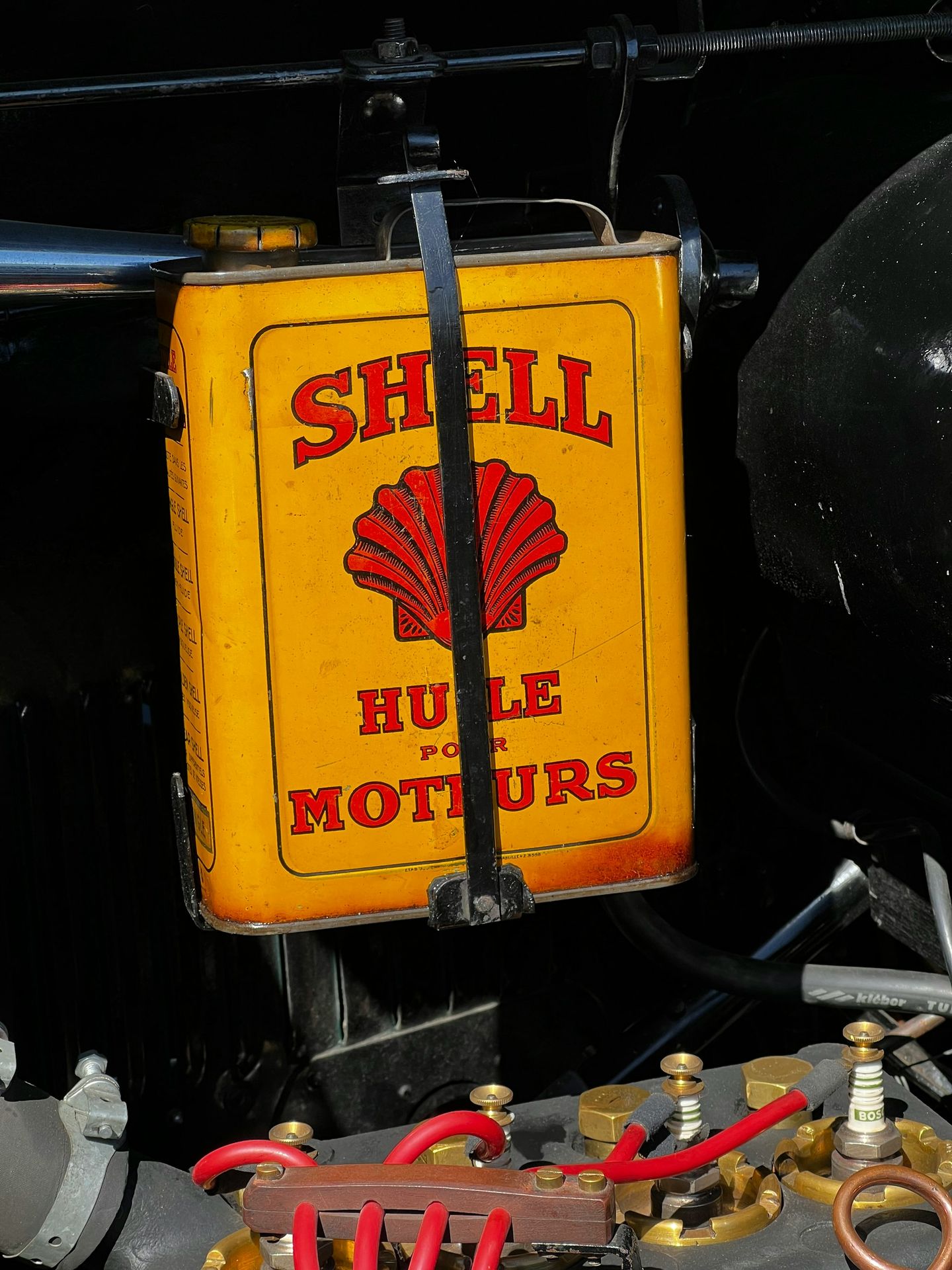 A yellow shell oil sign sitting on the side of a train